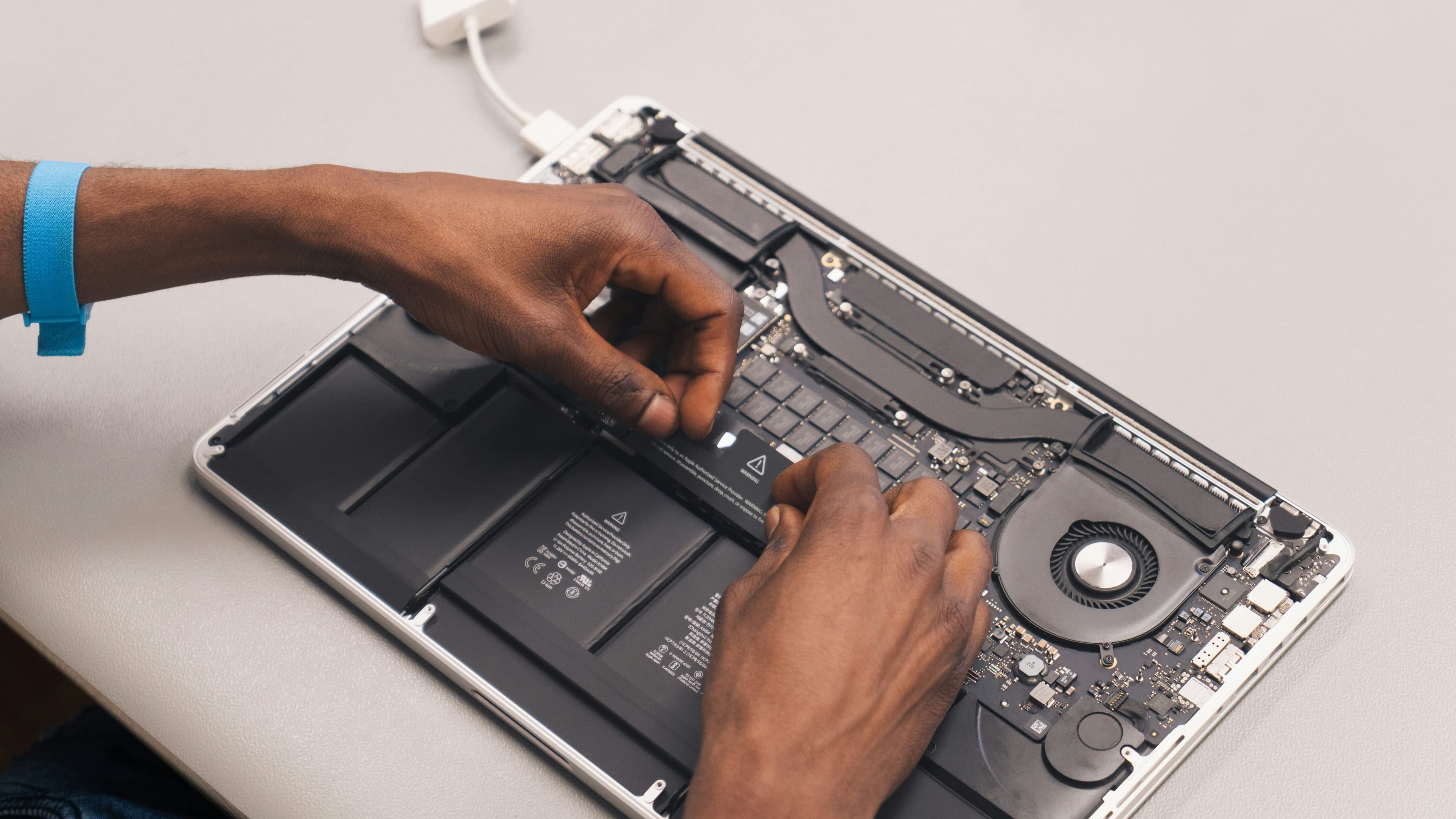 A technician repairing a computer at Blessing Computers